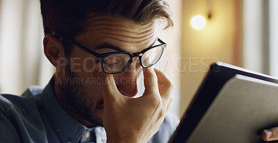 Buy stock photo Eye strain, tablet and man in home with headache for reading online blog, book or article. Social media, glasses and male person with migraine for visual fatigue on digital technology in house.