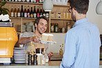 Barista, coffee and takeaway order with man in cafe for collection, hospitality or service. Giving, smile and to go with waiter serving customer at restaurant for pickup in small business startup