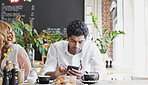 Phone, relax and man in cafe for online message, text or check social media for communication. Mobile, serious person and customer in coffee shop, internet chat or networking with morning breakfast