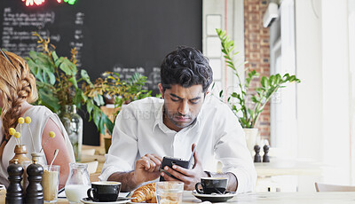 Buy stock photo Phone, relax and man in cafe for online message, text or check social media for communication. Mobile, serious person and customer in coffee shop, internet chat or networking with morning breakfast
