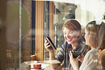 Coffee, phone and window with friends in cafe together for communication, sharing or social media. App, drink and text message with woman friends in restaurant for bonding, connection or reunion