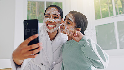 Buy stock photo Happy mom, girl and peace sign with face mask for selfie, social media post or spa day together. Mother, child or daughter with smile, facial treatment or app for morning routine or picture in home