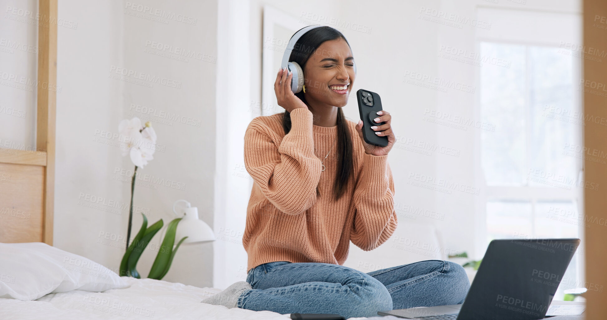 Buy stock photo Phone, headphones and woman in home, listening to music and digital app for song. Subscription, smile and person in bedroom, live streaming for radio and energy with online audio, singing and karaoke