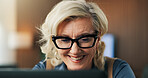 Businesswoman, smile and reading in office with laptop, glasses and good news for financial audit. Mature person, research and accounting in workplace with spectacles, computer and positive feedback.