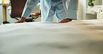Hands, travel and person tidy bed in hotel room for morning routine, habit or weekend getaway. Wake up, guest or fix blankets at lodge for cleaning space, getting ready or hygiene standard on holiday