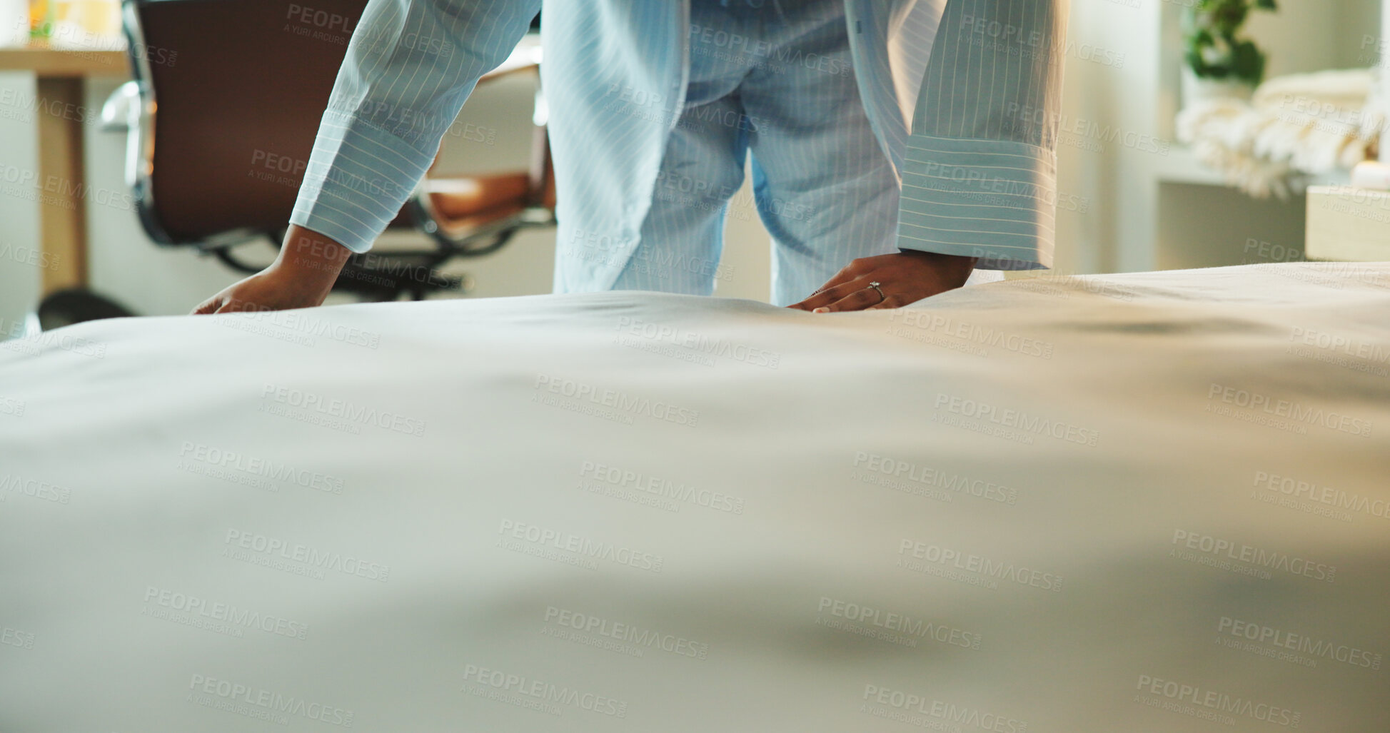 Buy stock photo Hands, blanket and person tidy bed in hotel room for morning routine, habit or weekend getaway. Wake up, guest and fix duvet at lodge for cleaning space, getting ready or hygiene standard on holiday