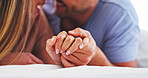 Love, couple and holding hands in bed for connection, relationship wellness and security together. Care, man and woman in bedroom with partner to relax at home, marriage commitment and affection