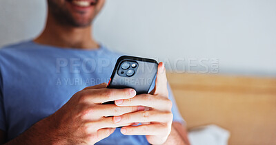 Buy stock photo Man, hands and typing with phone in bedroom for network connection, social media or browsing. Male person, communication or texting with smile on mobile smartphone for online chatting app in home