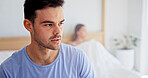 Conflict, decision and man in bedroom of home for argument, disagreement or relationship stress. Anxiety, fight and thinking with couple on bed in apartment for anger, fail or marriage mistake