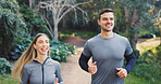 Fitness, happy or couple in nature with running, exercise together or bonding in physical activity. Smile, athletes or people on path with jog, cardio training or workout connection in active hobby.