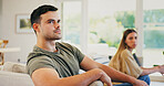 Upset, argument and man on sofa in home with conflict, breakup or cheating problem in relationship. Couple, disagreement and male person with fighting, divorce or affair drama in marriage at house.