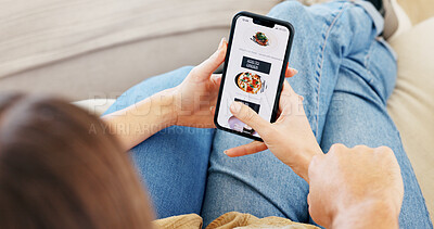 Buy stock photo Food, hands and phone screen for ecommerce with couple on sofa in living room of home together. App, menu scrolling and online order with people talking in apartment for decision, delivery or meal