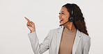 Pointing, headset and businesswoman by mockup space for advertising of call center in studio. Happy, mic and female technical support consultant with tips on customer service by white background.