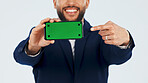 Green screen, phone and pointing with hands of businessman in studio for info, offer or promotion. Display, mockup space and tech with happy employee on white background for announcement or review