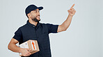 Delivery man, box and pointing in studio for shipping guide, info or steps for courier service. Happy person, package or parcel with logistics, dropshipping menu or list with mockup on background