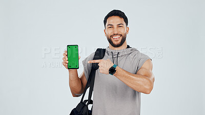 Buy stock photo Green screen, phone and portrait of bodybuilder in studio with space for gym subscription. Happy, man and athlete pointing to cellphone for fitness app, website or blog on tech by white background.
