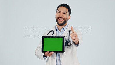 Buy stock photo Doctor, portrait or happy man with thumbs up, tablet or green screen for advertising Telehealth app. Male person, healthcare worker or like emoji with technology or mockup space on a white background