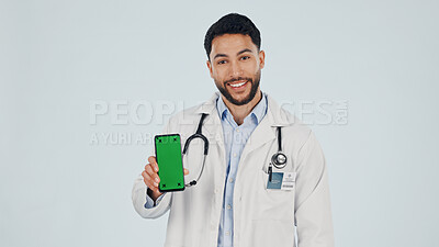 Buy stock photo Green screen, man and portrait of doctor with phone in studio for clinic sign up, FAQ and telehealth. Cellphone, happy and healthcare worker on mobile app for medical information by white background.