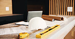 Construction, blueprint and helmet with laptop for renovation, building design or planning. Architecture, equipment and floor plan on site for real estate development, safety gear or drafting