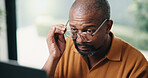 Author, glasses and black man with laptop in home for online book, reading or digital manuscript. Male person, writer or spectacles on computer for article publication, story writing or news in house