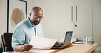 Laptop, finance and black man with documents in home for budget planning, audit or expenses. Male person, accounting or paperwork with computer for financial assessment, review or report in house