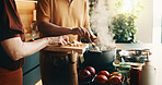 Kitchen, stove and hands of couple for cooking, cuisine and meal prep for dinner or lunch. Marriage, home and people with knife, vegetables and ingredients for recipe, culinary skills and helping