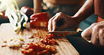 Kitchen, cutting and hands of couple for cooking, cuisine and meal prep for dinner or lunch. Marriage, home and people with knife, vegetables and ingredients for recipe, culinary skills and help