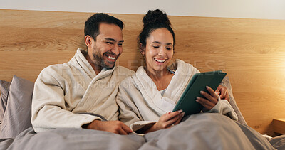 Buy stock photo Happy couple, online and relax with tablet in bedroom, entertainment and streaming movies on website. Watching, film and people with technology, internet connection and bonding with partner in house