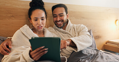 Buy stock photo Happy couple, scroll and relax with tablet in bedroom, entertainment and streaming movies on website. Watching, film and people with technology, internet connection and bonding with partner in house