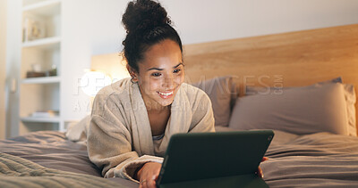 Buy stock photo Chilling, home and happy woman with tablet on bed, reading or ebook subscription in bedroom at night. Evening, reader and person with tech for story, internet connection and novel download in house