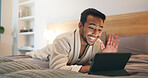 Hotel, bed and man on tablet for video call, social networking and online conversation on trip. Happy, night and person wave on digital tech for hello, communication and travel update at resort