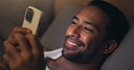 Night, happy and man with phone in bed for social media, chat and browse internet for contact. Home, bedroom and person on cellphone for connection, website and check notification for entertainment
