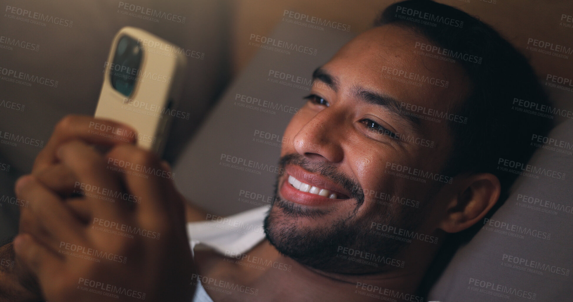 Buy stock photo Night, happy and man with phone in bed for social media, chat and browse internet for contact. Home, bedroom and person on cellphone for connection, website and check notification for entertainment