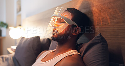 Buy stock photo Man, relax and light with uv mask in bed for facial, skincare or anti aging treatment in home. Beauty, male person or red LED cosmetics for skin protection, collagen or blood circulation in bedroom
