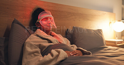 Buy stock photo Woman, relax or light with uv mask in bed for facial, skincare or anti aging treatment in home. Beauty, female person or red LED cosmetics for skin protection, collagen or blood circulation in house