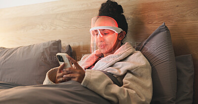 Buy stock photo Red light, dermatology and woman with phone in bedroom for beauty, wellness and collagen production. Health, relax and person in bed with LED phototherapy tech for skincare or mask treatment in home