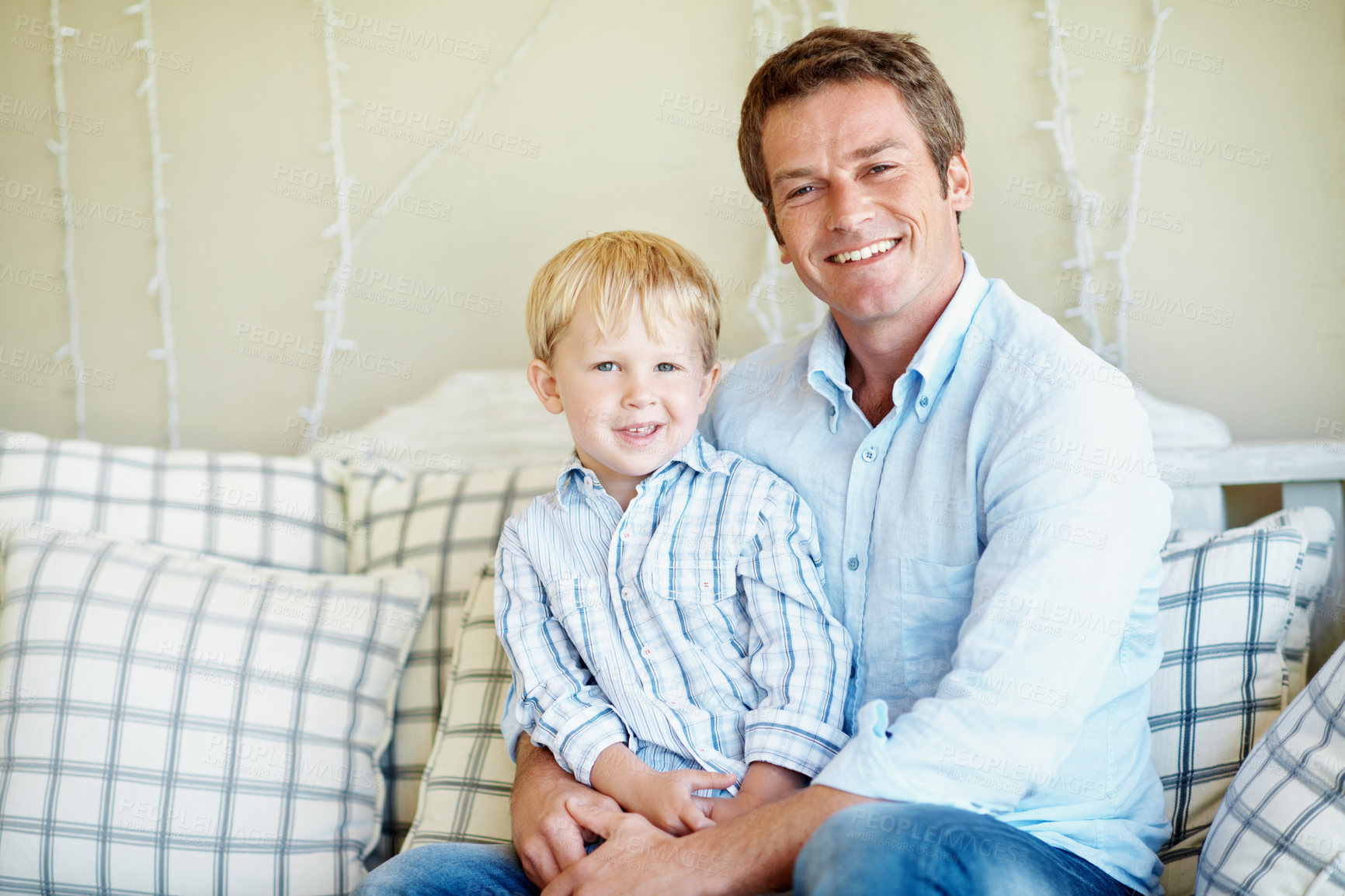 Buy stock photo Happy, portrait and dad with son on sofa for bonding, relationship and love for fathers day. Family, smile and man with child on couch for connection, support and relax together on weekend in home