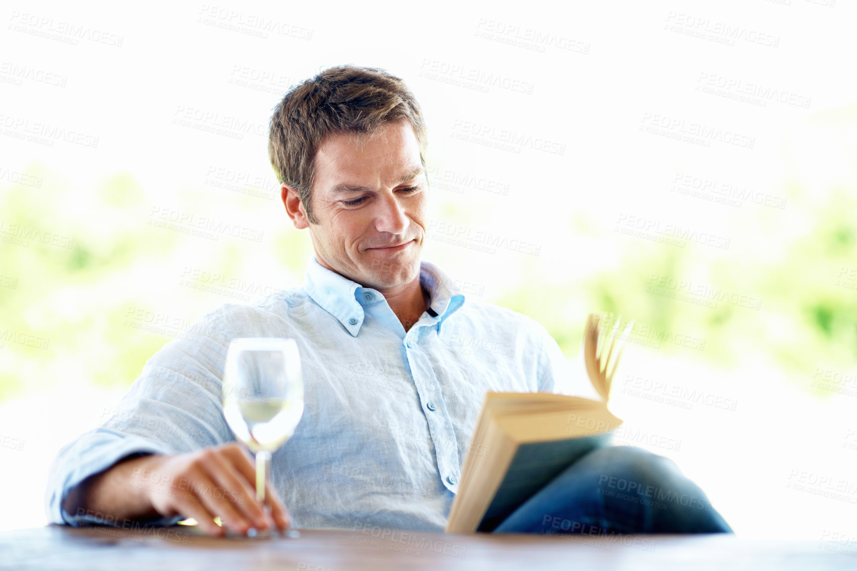 Buy stock photo Book, knowledge and happy man with wine glass on break, reading and chill with literature and story. Fiction, reader and person with alcohol on weekend, smile and relax with novel or entertainment