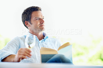 Buy stock photo Relax, wine and man in backyard for reading book, hobby and thinking with drink on weekend. Happy, patio and person with alcohol, thoughtful and reflection for story, novel and literature for break
