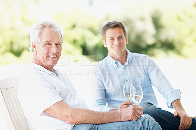 Buy stock photo Happy, wine and portrait of senior parent for bonding, chat and relax in backyard on weekend. Family, garden and man with elderly dad, alcohol and drinks for connection, relationship and talking