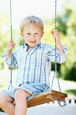 Buy stock photo Portrait, fun and child on swing at park, fine motor skills and development in nature and fresh air. Outdoor, playground and kid with smile on weekend, play and boy with positive attitude and growth