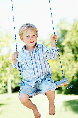 Buy stock photo Child, portrait and play on swing at park, fine motor skills and development in nature and fresh air. Outdoor, playground and kid with smile on weekend, fun and boy with positive attitude or growth