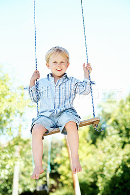 Buy stock photo Child, portrait and play on swing at playground, fine motor skills and development in nature and fun. Outdoor, park and kid with smile on weekend, growth and boy with positive attitude or fresh air