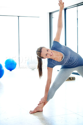 Buy stock photo Fitness, smile and stretching with woman in pilates studio for health or wellness routine. Exercise, reaching and warm up with happy person training for balance, development or holistic workout