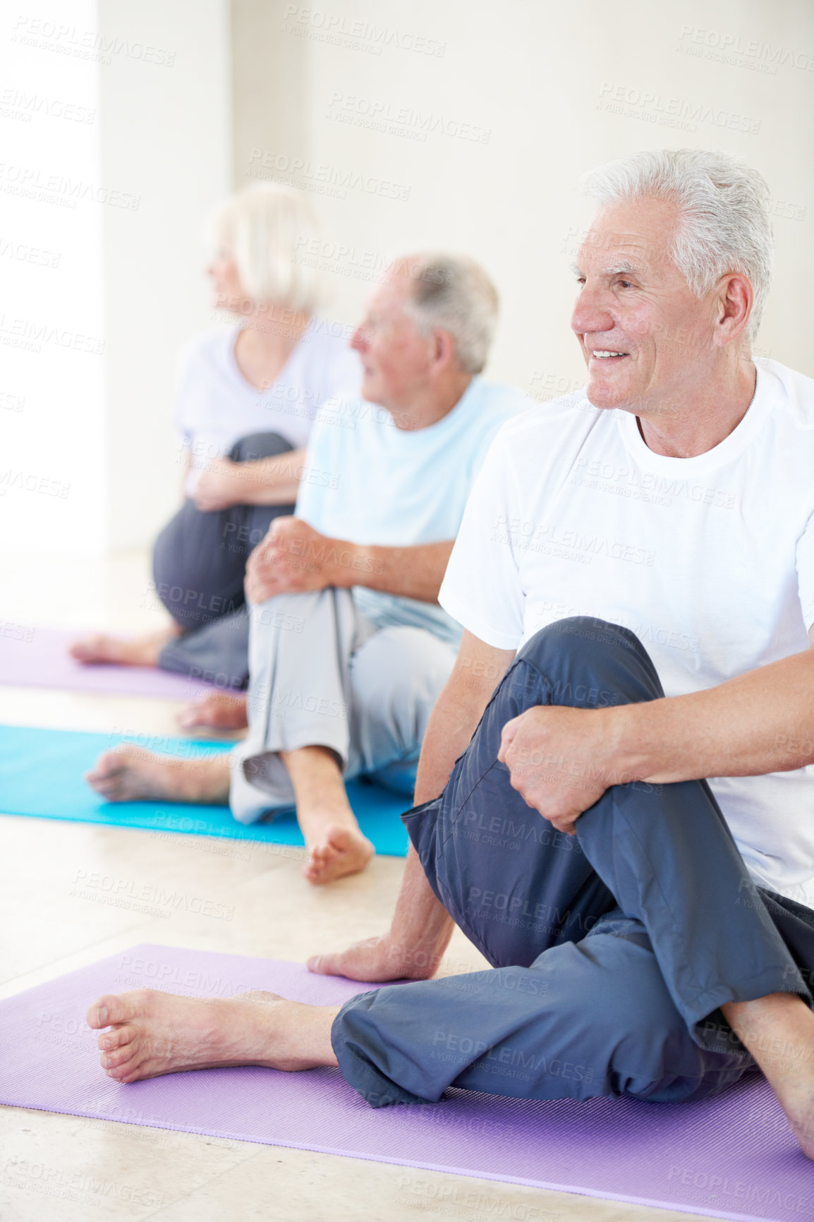 Buy stock photo Yoga, old man and smile with stretching in class for spine flexibility, mobility exercise or health. Group, senior person and lord of the fishes pose in studio for fitness, wellness or muscle warm up