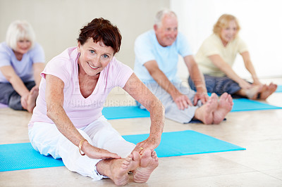 Buy stock photo Senior woman, portrait and stretching in gym class for pilates, preparation and wellness. Old people, instructor and group in health club with warm up, mobility workout or fitness for retirement