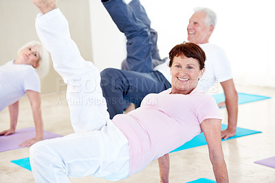 Buy stock photo Stretching, portrait and elderly woman in yoga class for wellness, happy and balance in retirement. Senior resident, smile and bridge pose in health club for core exercise, fitness and cardio