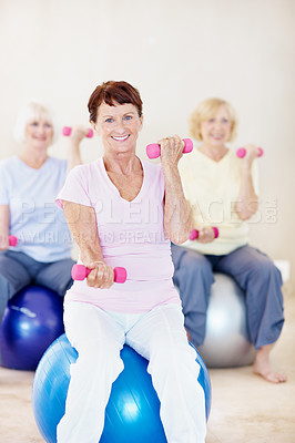 Buy stock photo Portrait, dumbbells and old woman on ball with gym class, balance or smile for retirement wellness. Active, senior person and group in health club with weights, strength training or happy for fitness