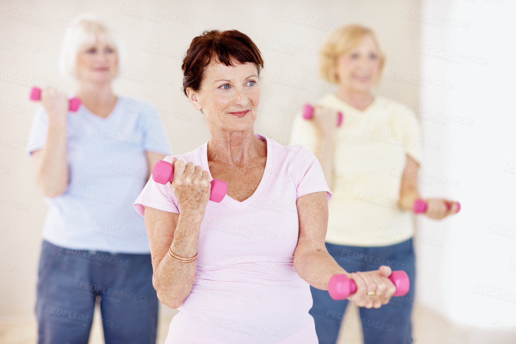 Buy stock photo Dumbbells, exercise and old woman in gym class with group, workout and smile for retirement wellness. Active, senior person and vitality in health club with weights, strength training and fitness.
