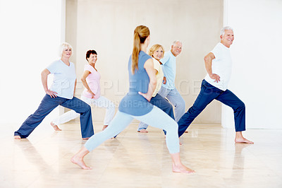 Buy stock photo Pilates, instructor and stretching with elderly people for wellness, support and fitness in retirement. Senior group, trainer and lunge at facility for teaching, muscle warmup and exercise class